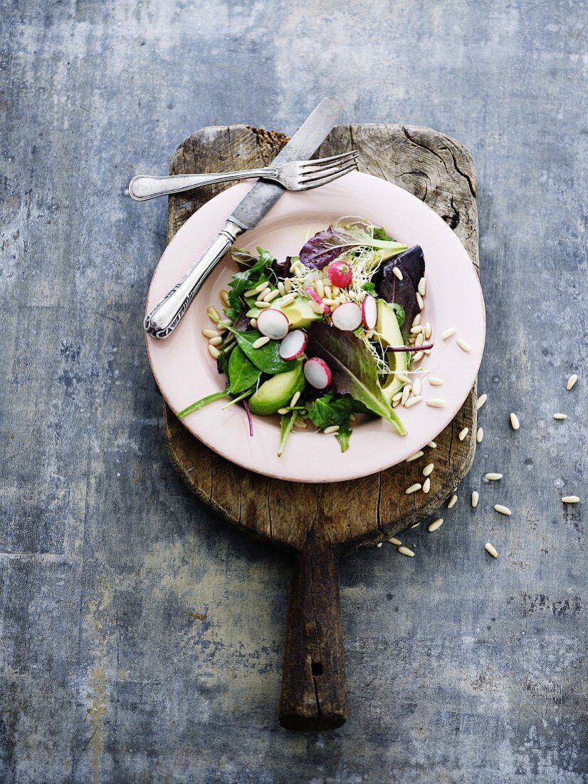 Blattsalat mit Avocado, Radieschen und Pinienkernen