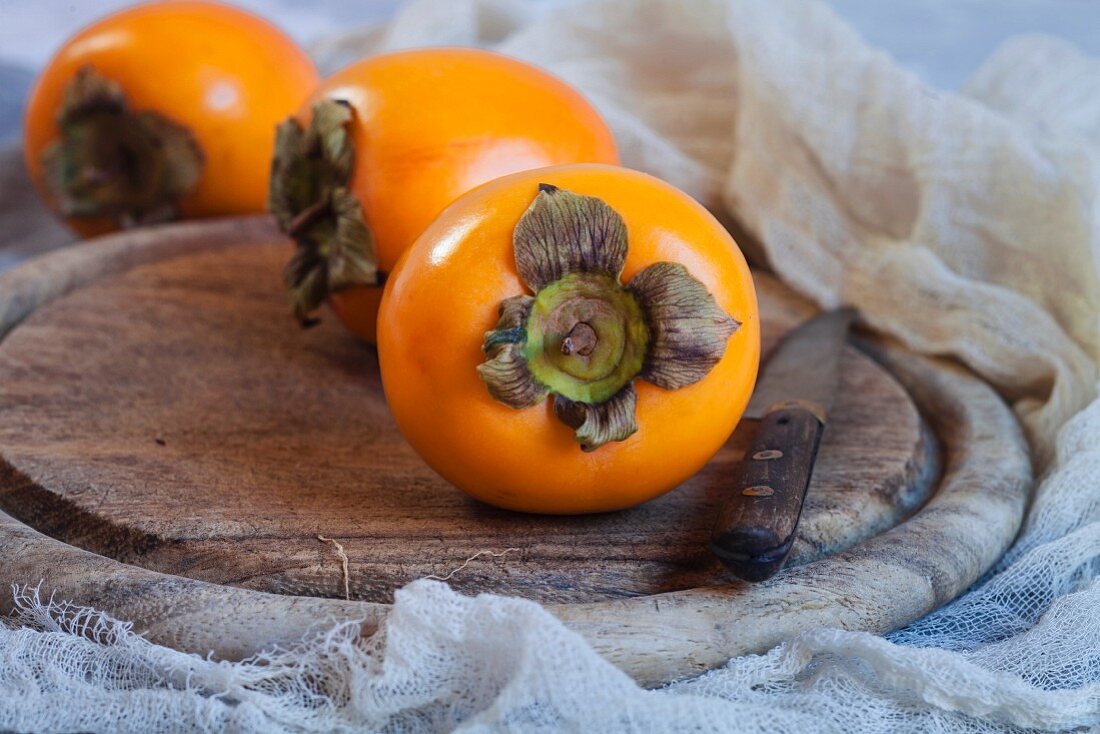 Persimmons on a wooden board