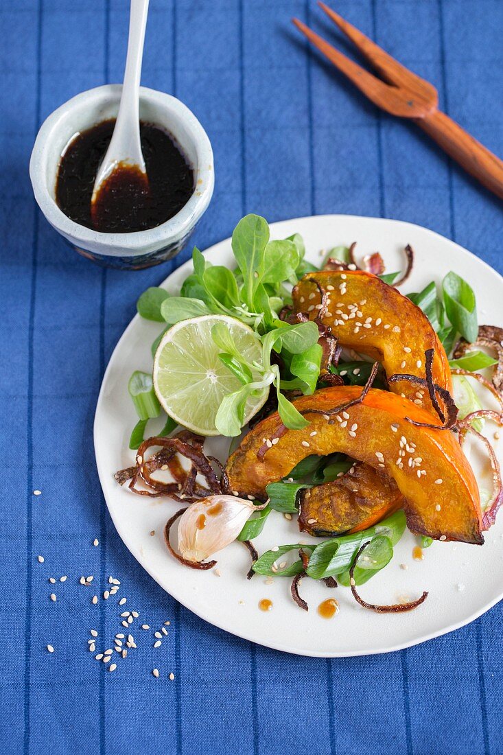 Baked Hokkaido pumpkin wedges with lamb's lettuce and soy sauce