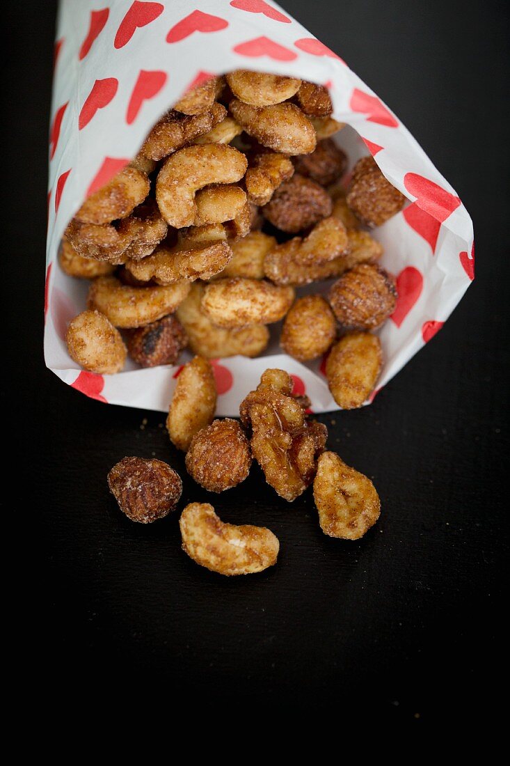Roasted nuts in a paper bag printed with hearts