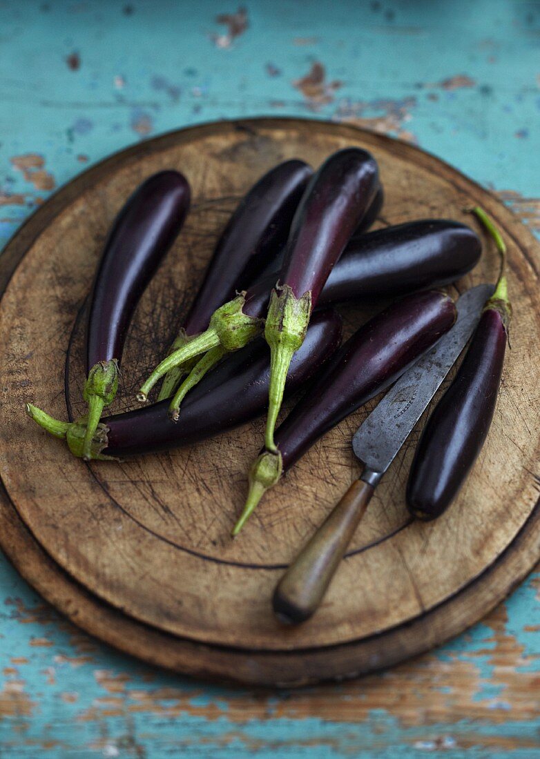 Aubergines on a wooden chopping board