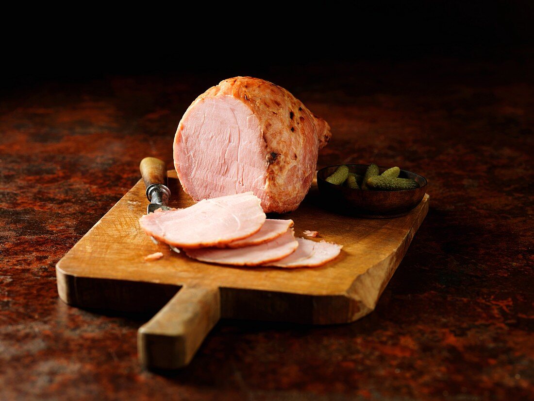 Carved Wiltshire ham on a chopping board