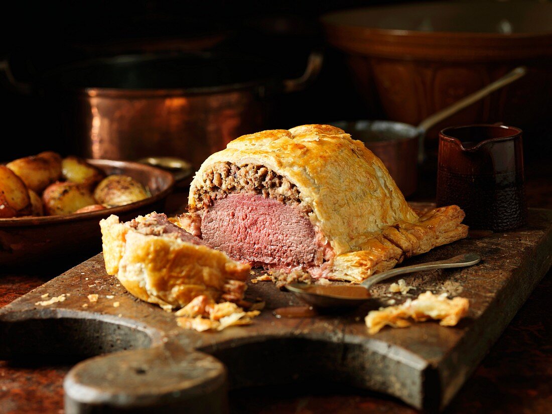 Carved venison Wellington on a chopping board