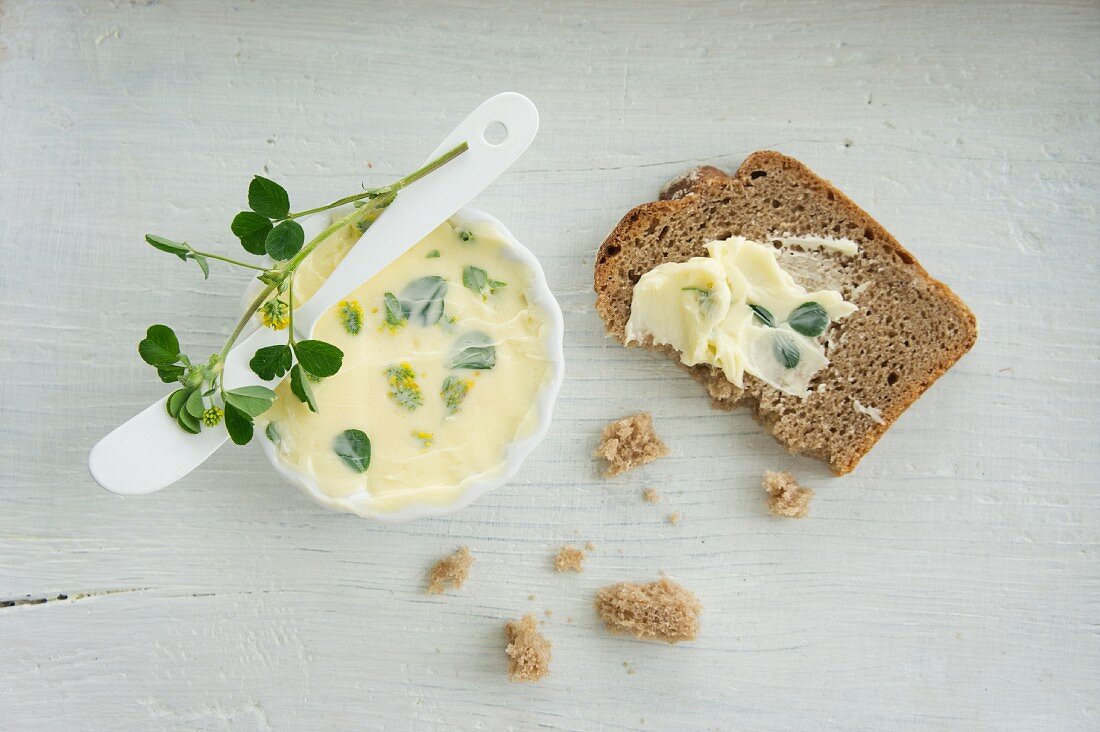 Hops clover butter in a small dish and spread on a slice of bread