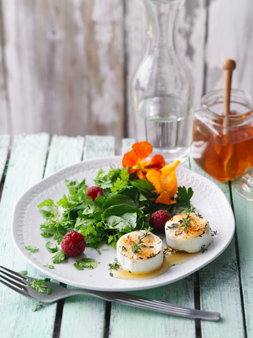 Herb salad with goat's cheese and raspberries