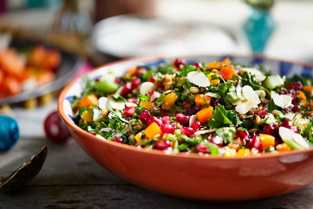Herb salad with pomegranate seeds and flaked almonds