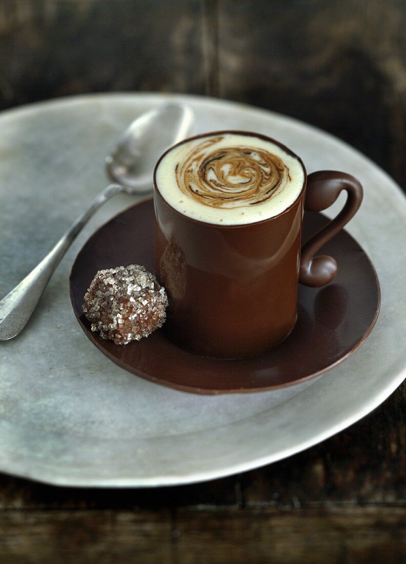 A cup of coffee and a praline