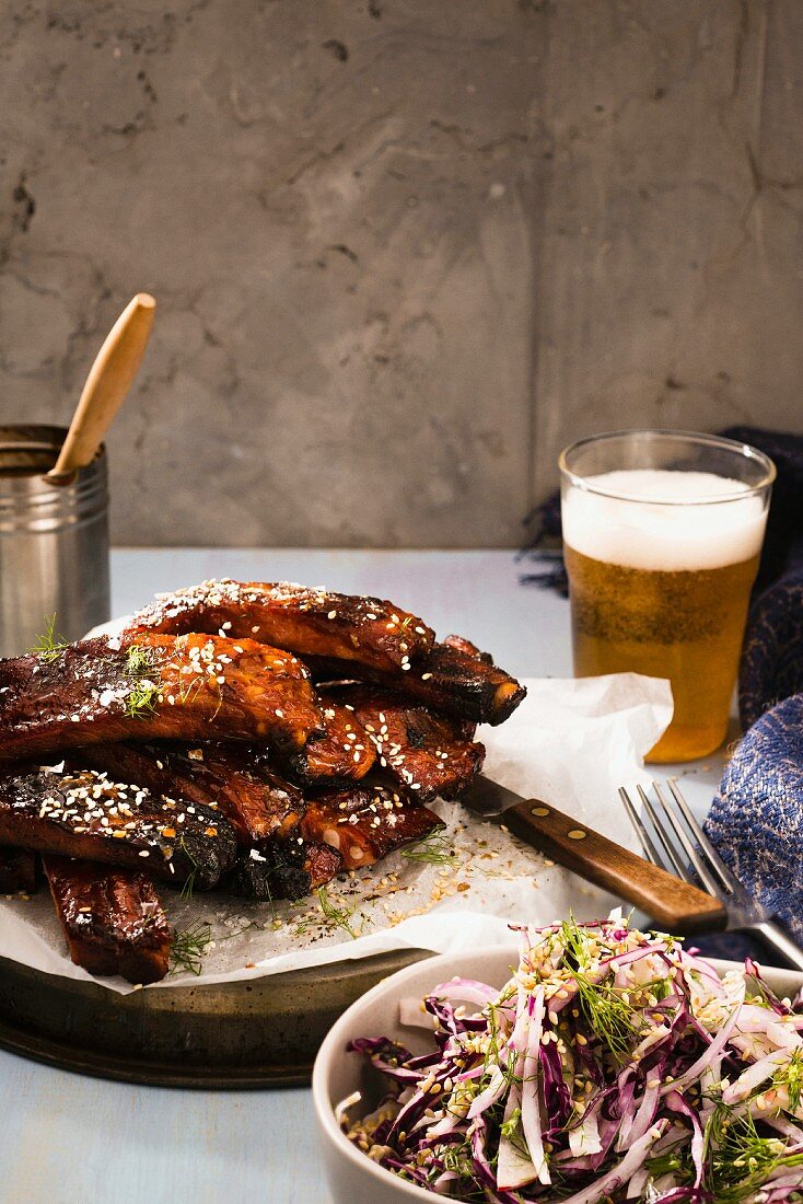 Glazed pork ribs served with coleslaw and a glass of ginger and peppermint beer