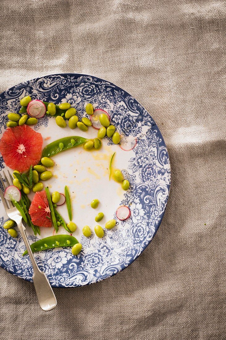 A half-eaten grapefruit and edamame bean salad with a sweet-and-spicy ginger sauce