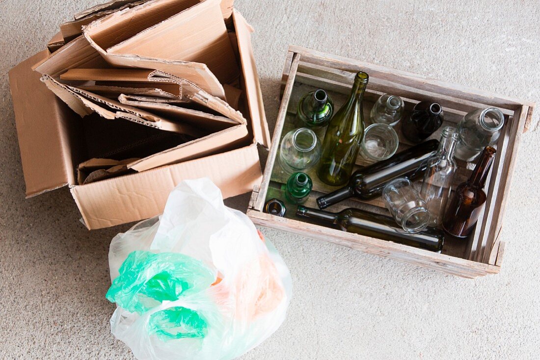 Waste separation: paper, empty glass bottles and plastic rubbish