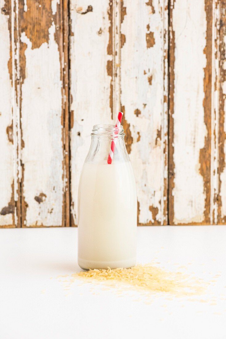 A bottle of rice milk with a straw