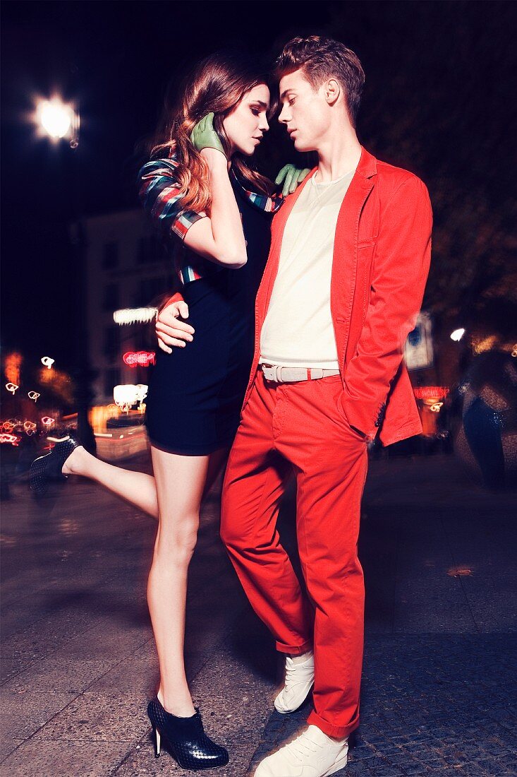 Young couple on street at night