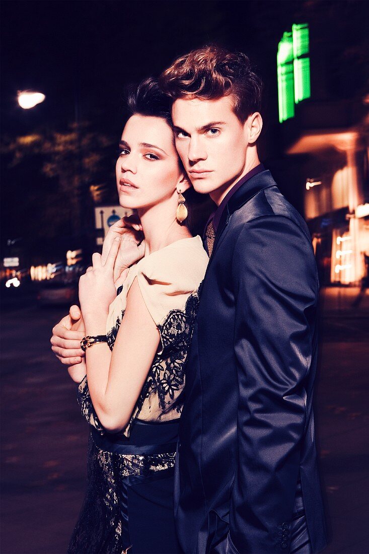 Young couple on street at night