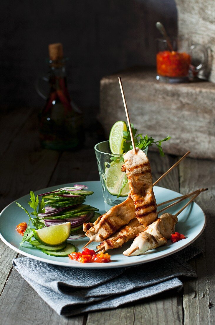 Chicken skewers with cucumber salad and chilli sauce