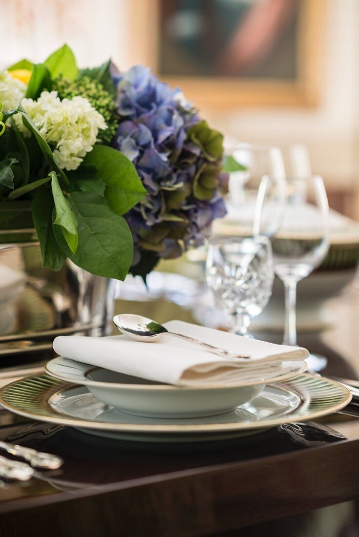 Elegant place setting with blue hydrangeas for a celebratory dinner