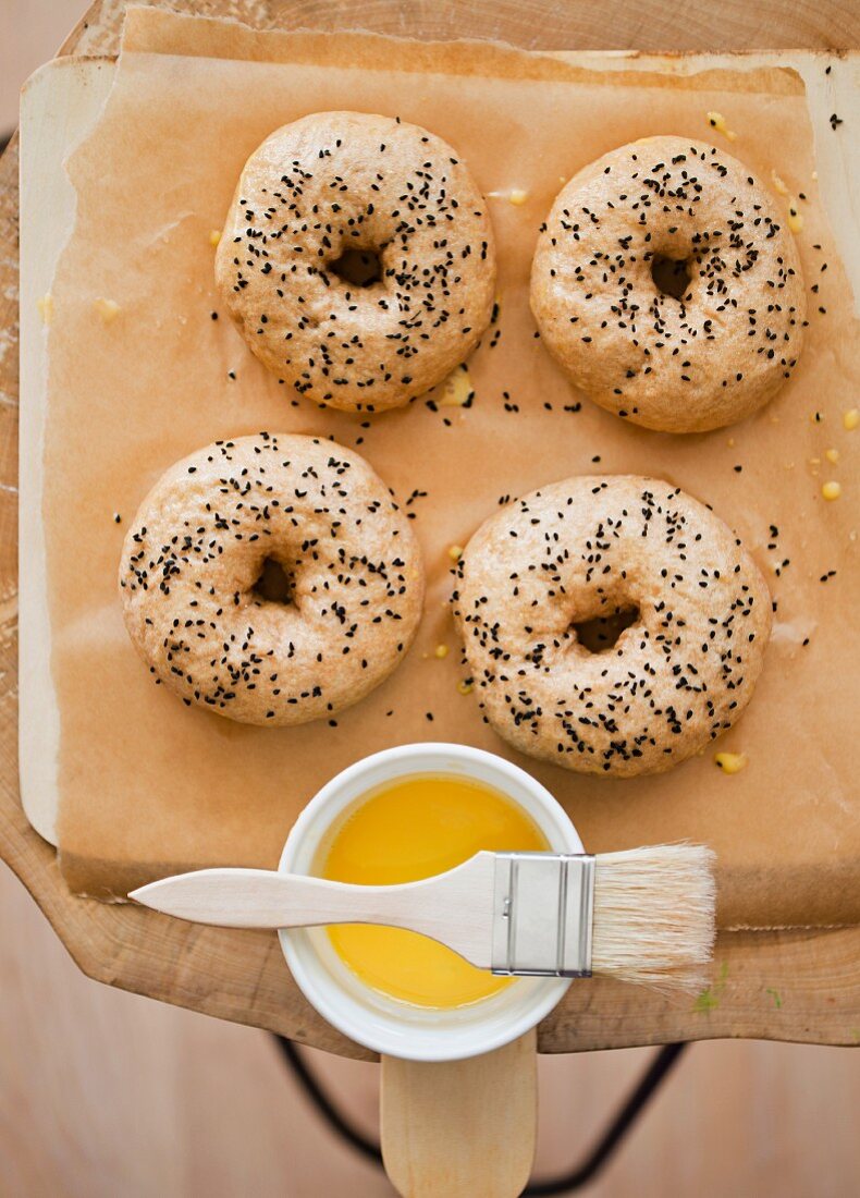 Bagels with black caraway seeds on a piece of baking paper