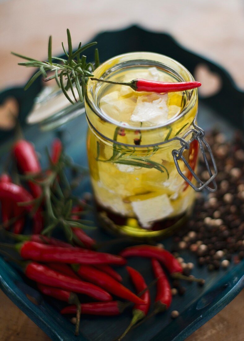 Pickled feta cheese with rosemary, chilli peppers and peppercorns