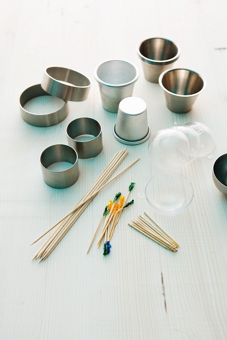 Various kitchen utensils: metal rings, moulds and wooden sticks