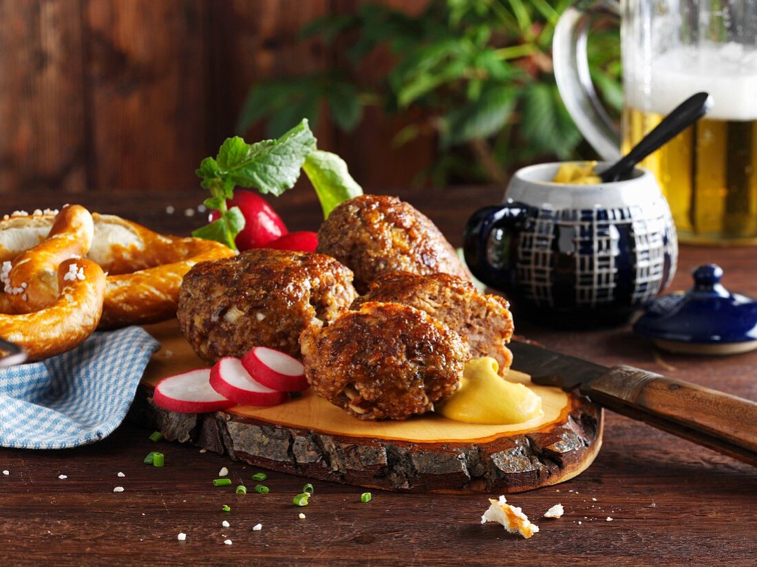 Meatballs with radishes, mustard and pretzels