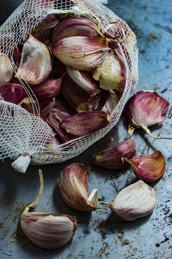 Cloves of garlic in a white net