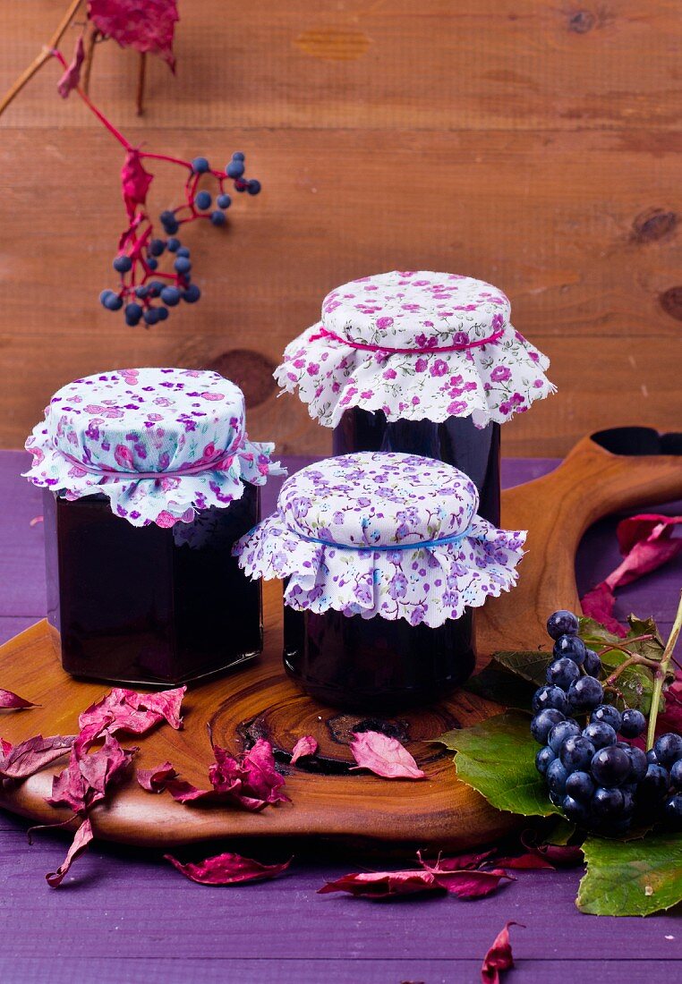 Jars of grape jelly with autumnal leaves