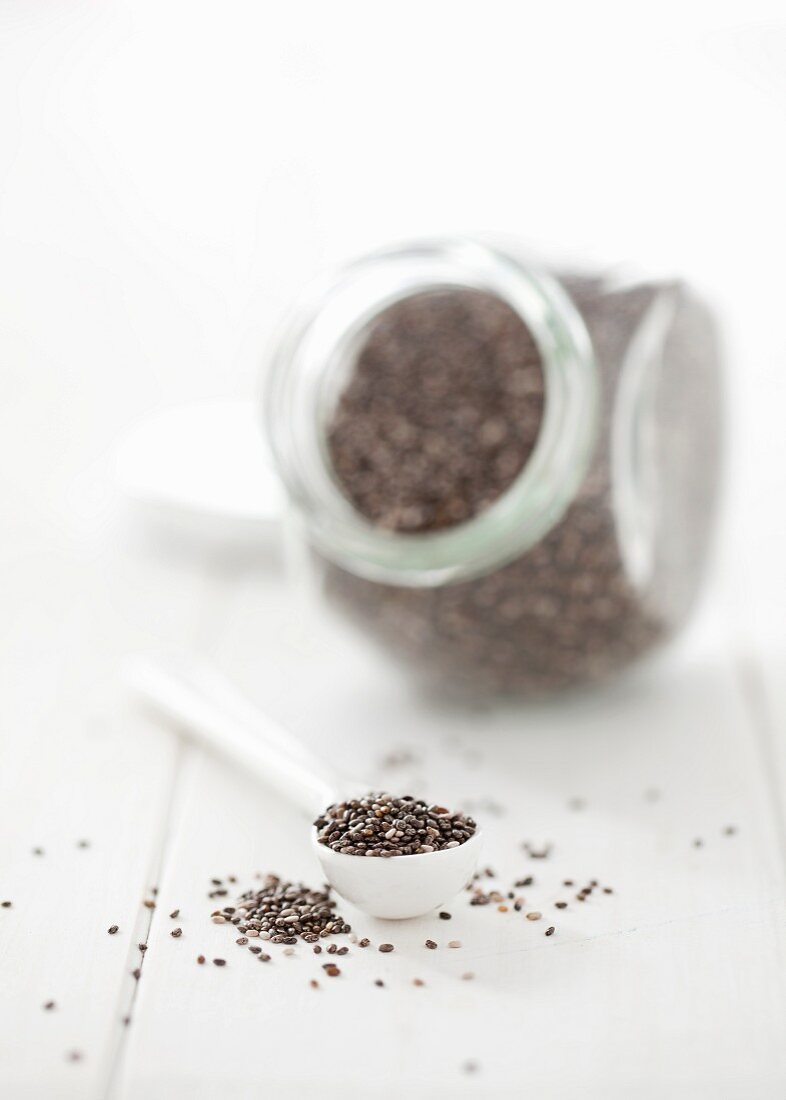 Chia seeds on a spoon and in a storage jar
