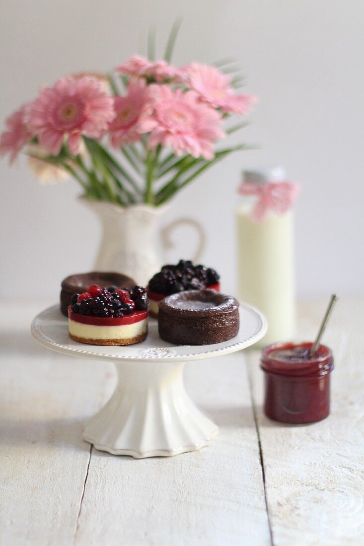 Chocolate cakes, berry tartlets and a jar of jam