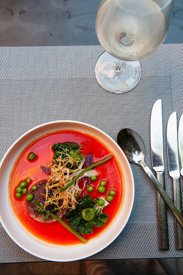 Tuna fish and hamachi tatar in gazpacho with bok choy, peas and frisee lettuce