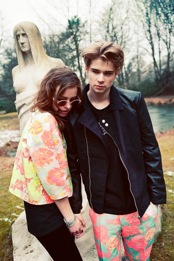 A young couple holding hands in a park