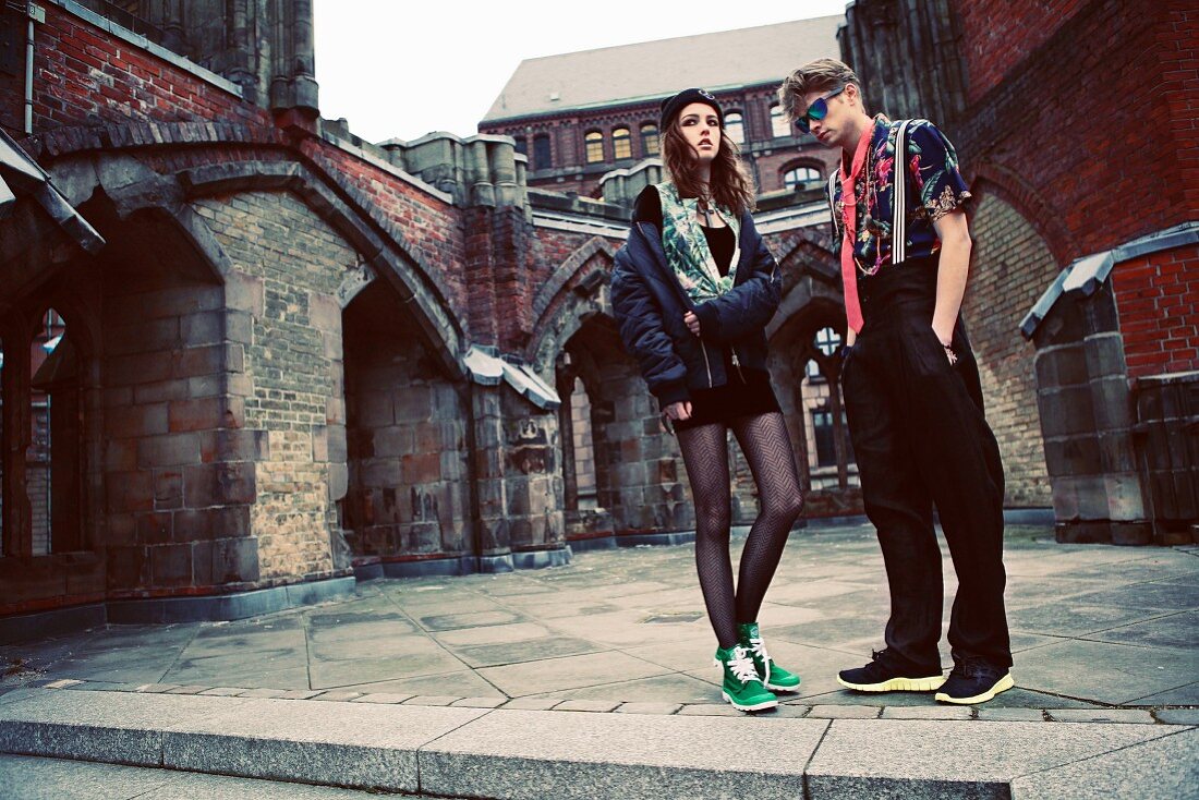 A young couple in the inner courtyard of an old church