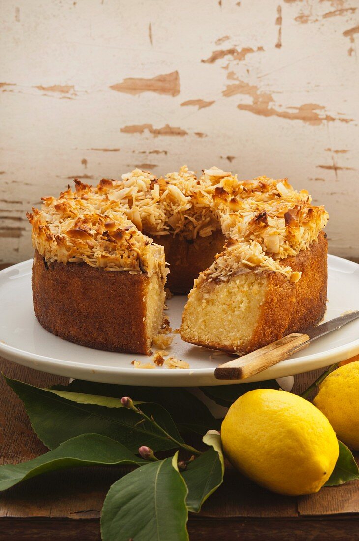 Citrus cake topped with grated coconut, sliced
