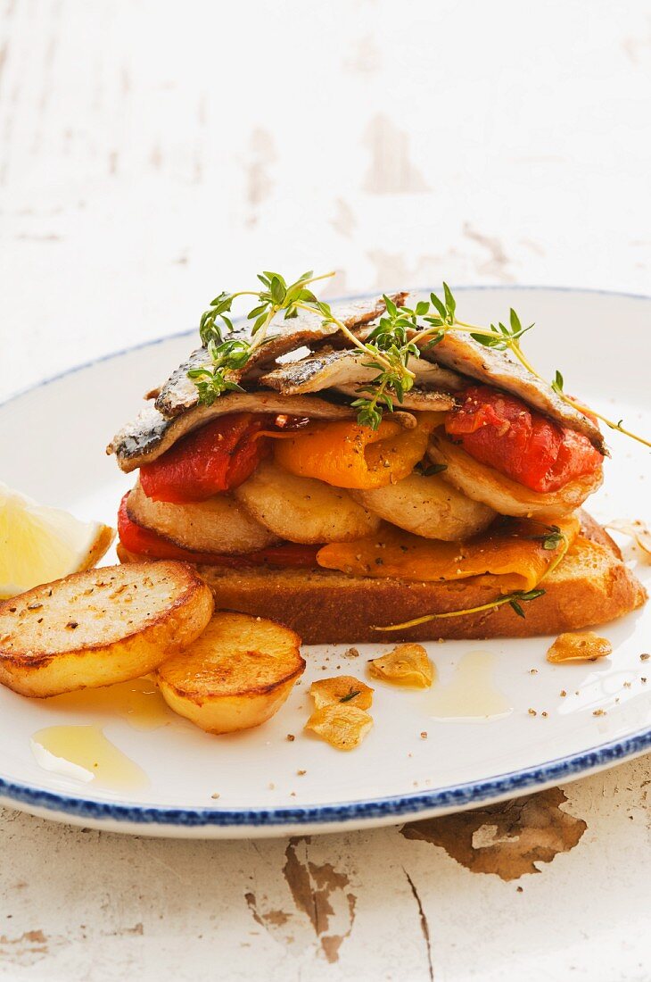 Toast topped with sardines and vegetables