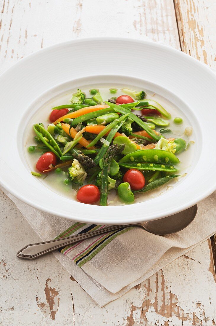 Spring vegetable soup with cherry tomatoes