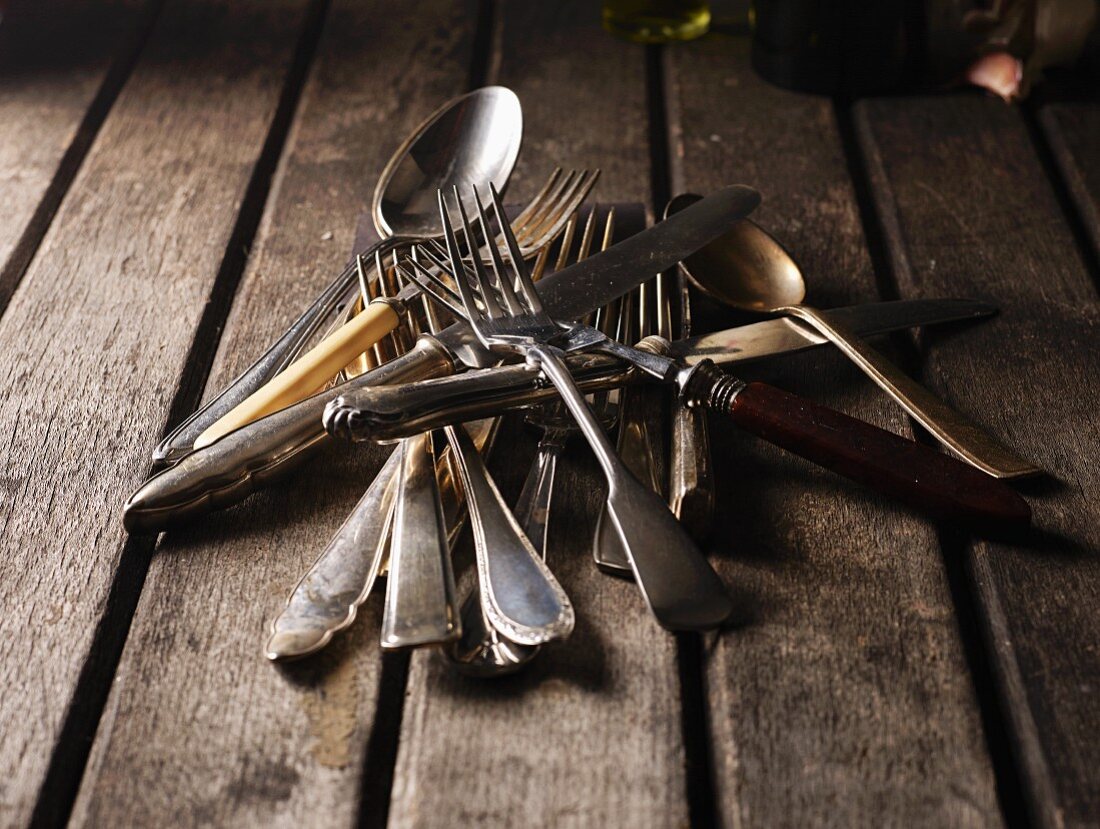 Old silver cutlery on a wooden table