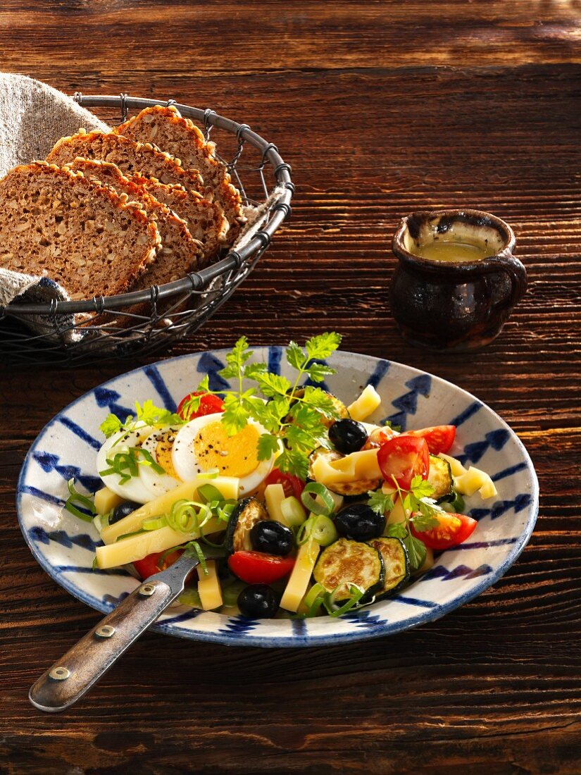Cheese salad with courgette, tomatoes, eggs and olives