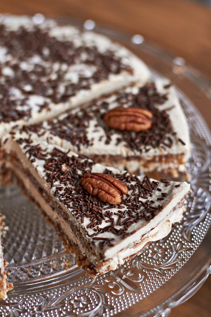 Apple and cinnamon pie with chocolate sprinkles and pecan nuts