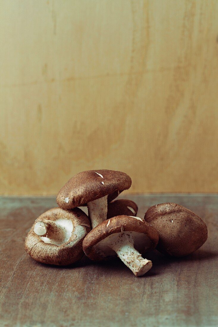 Shiitake mushrooms on a brown surface