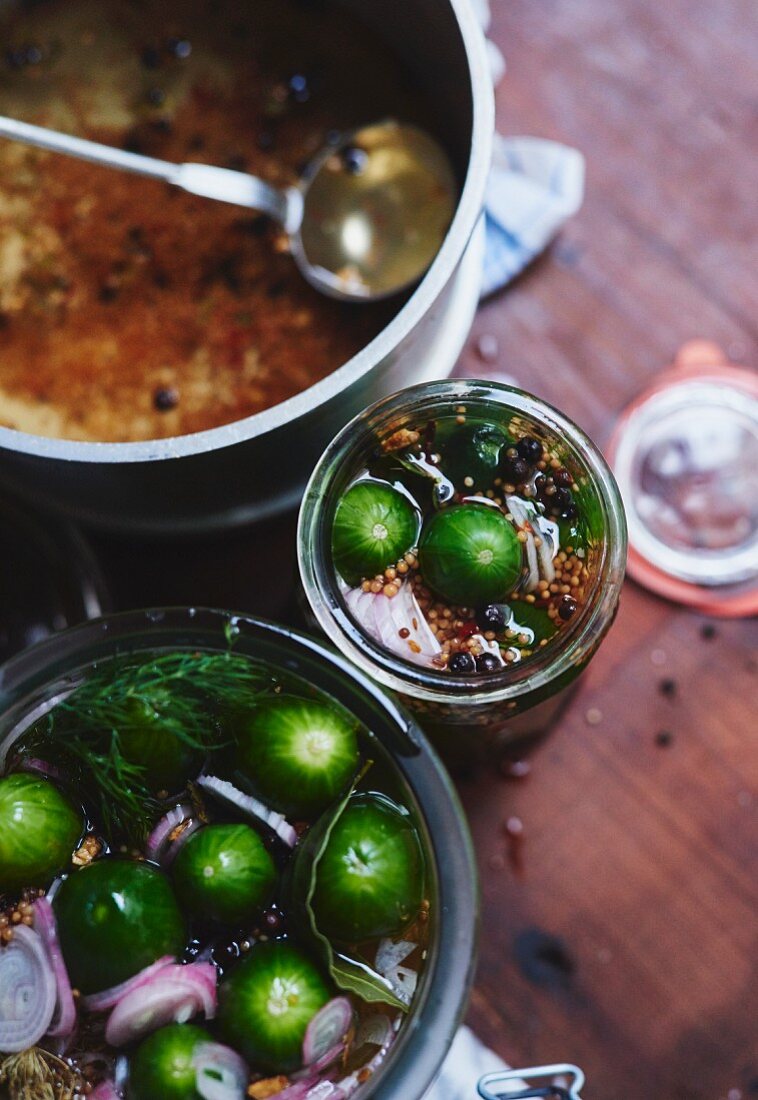 Homemade gherkins with spices being made