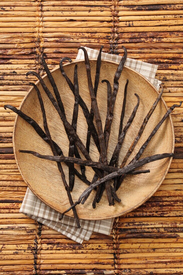 Vanilla pods on a wooden plate
