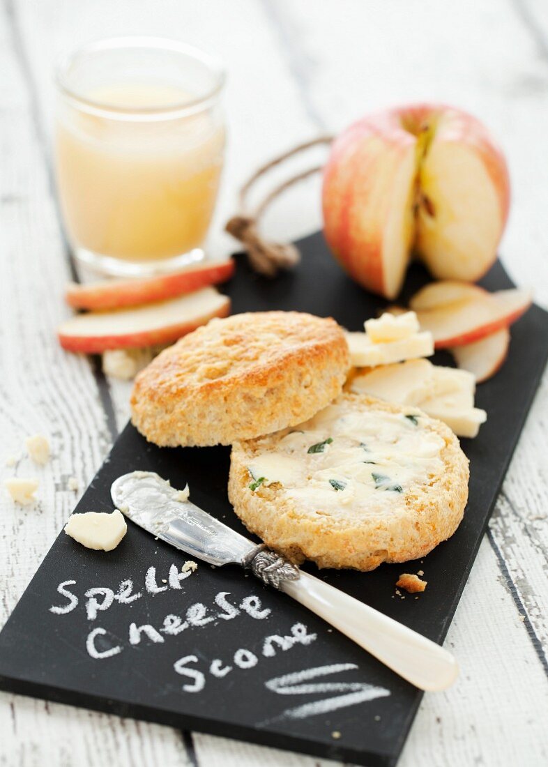A cheese scone with herb butter, cheese and apple