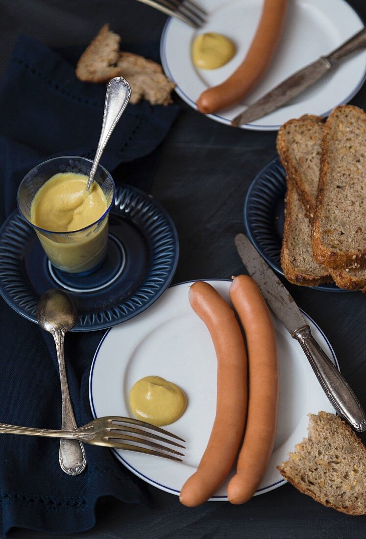 Hot dog sausages with mustard and bread