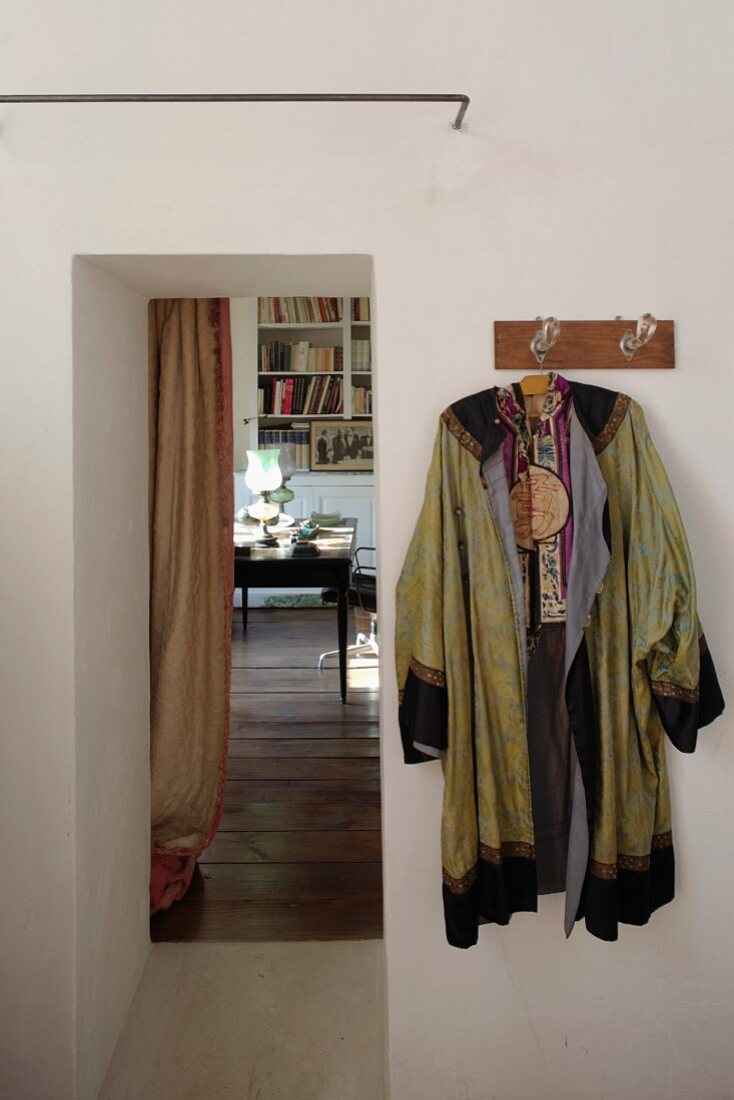 Kimono hung from coat rack next to open doorway