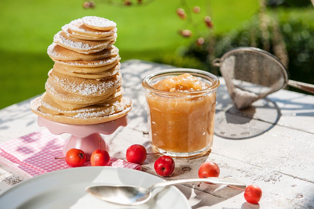 Apple sauce and pancakes on a garden table