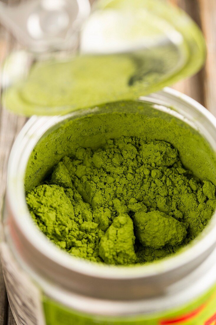 Matcha tea powder in a plastic container (close-up)