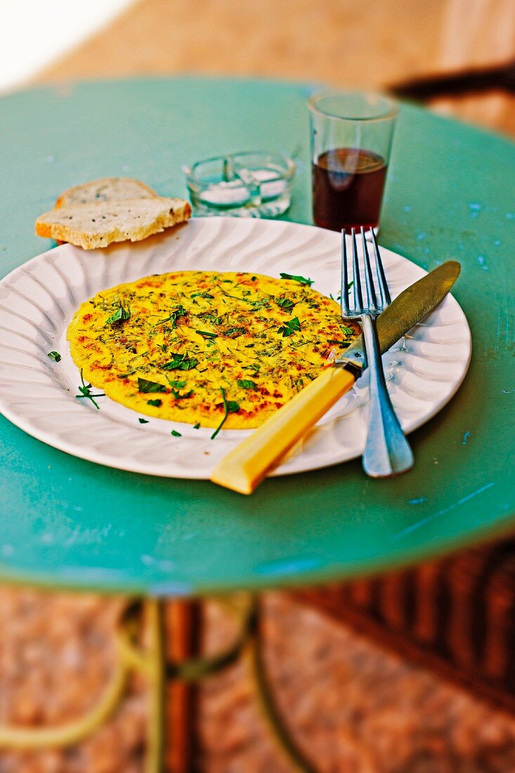 Herb omelette with bread and red wine