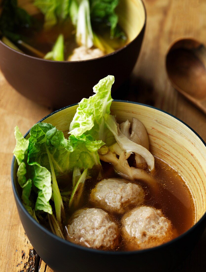 Mushroom soup with meatballs and cabbage leaves