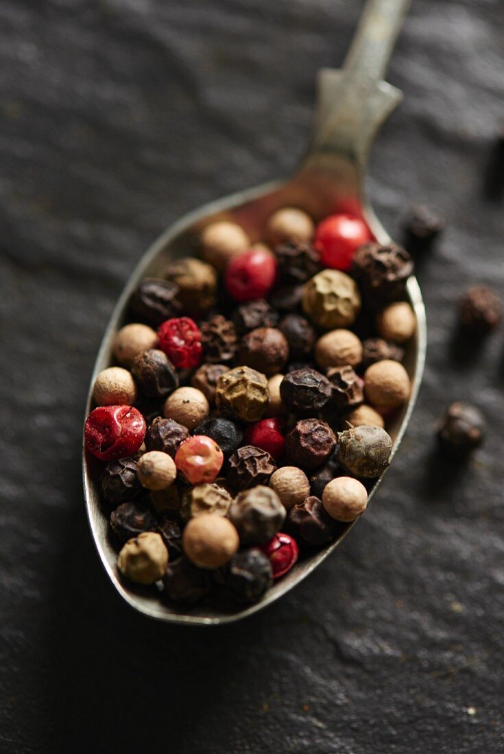 Mixed peppercorns on a spoon