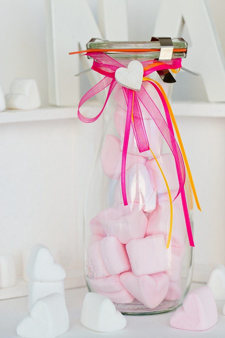 Pink, heart-shaped mashmallows in a glass bottle as a gift