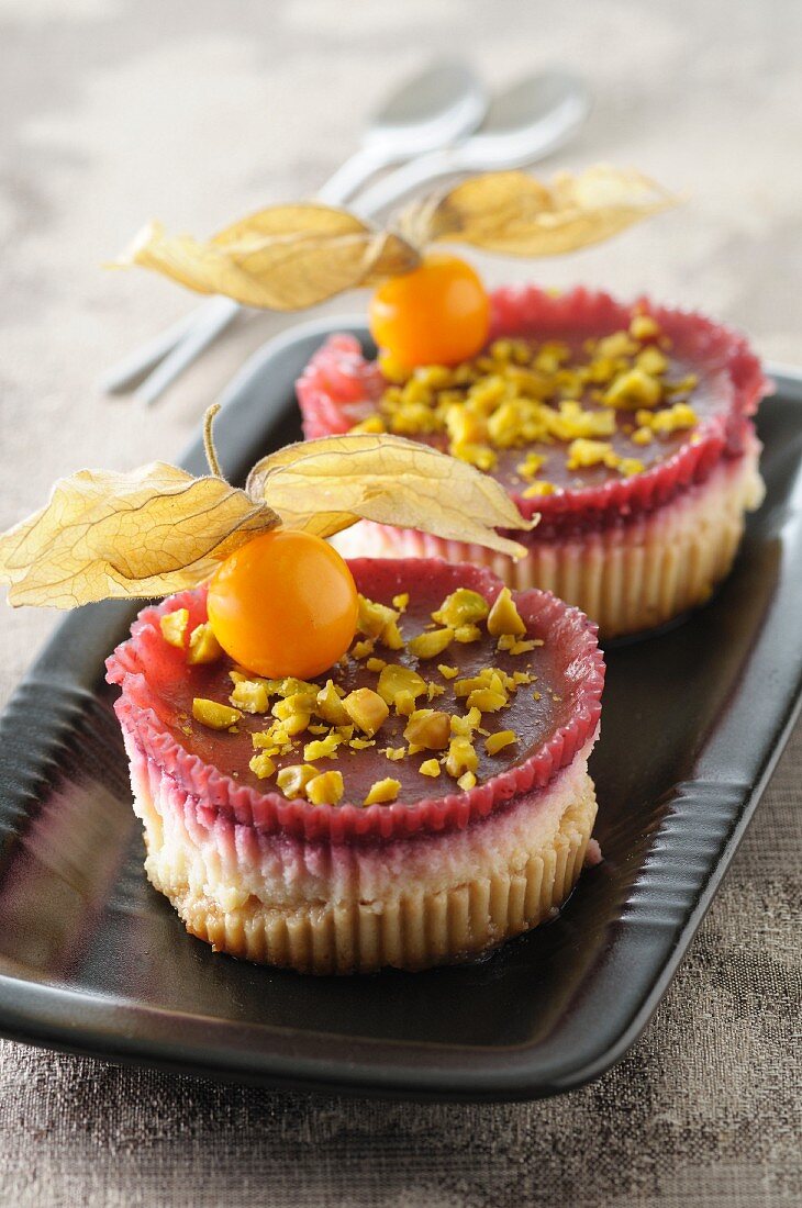 Mini cheesecakes with red fruits, physalis and pistachios