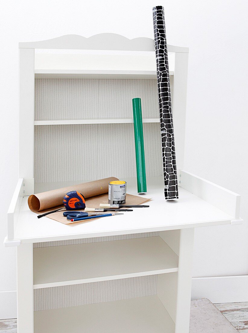 Vintage baby-changing cabinet and rolls of paper